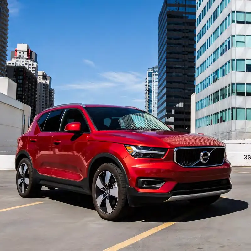 A red Volvo SUV parked downtown